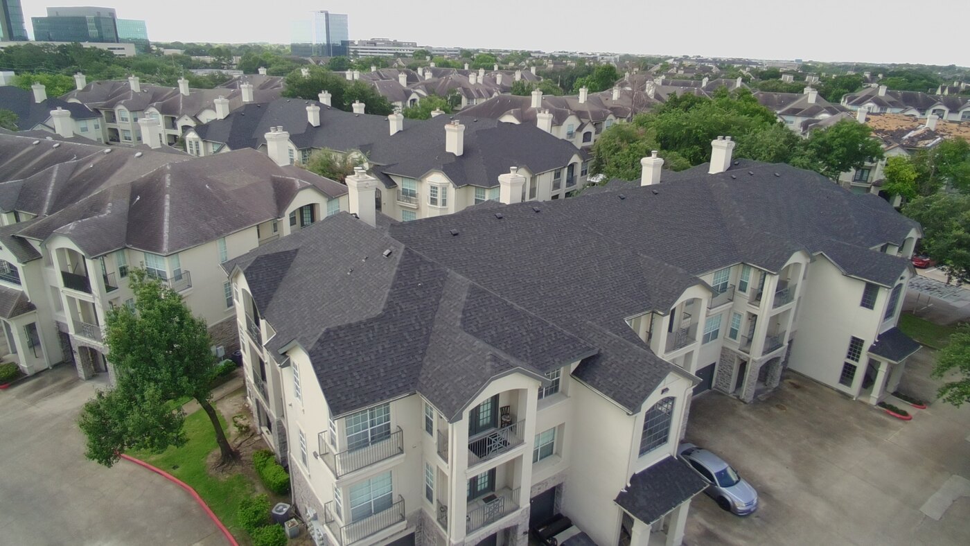 Completed dark shingle roofs across an apartment community