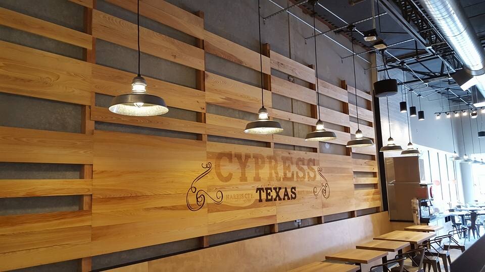 Finished restaurant wood feature wall with pendant lighting