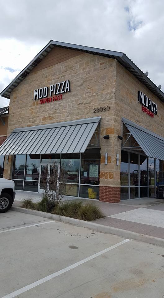 Completed MOD Pizza exterior with stone facade and metal awnings