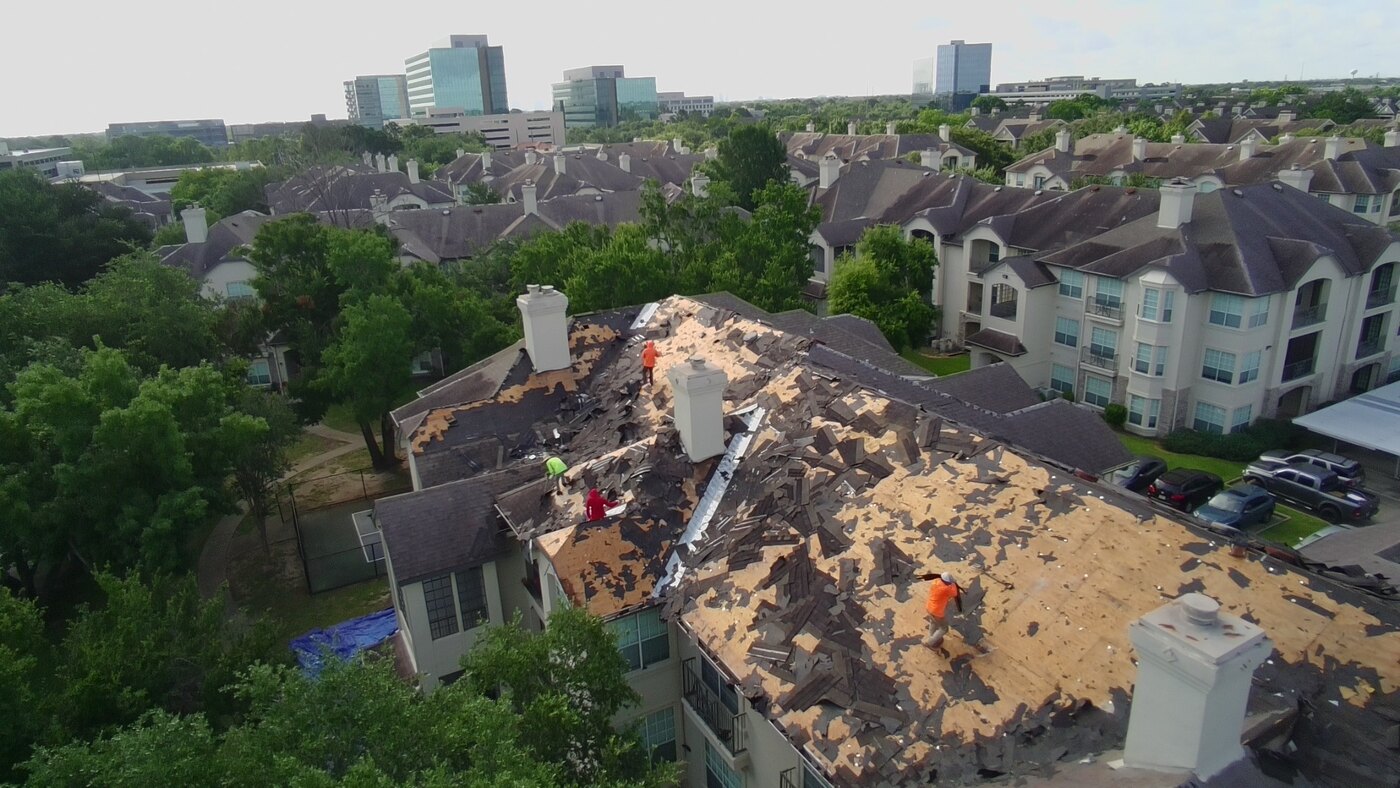 Aerial view of roof replacement with exposed roof decking